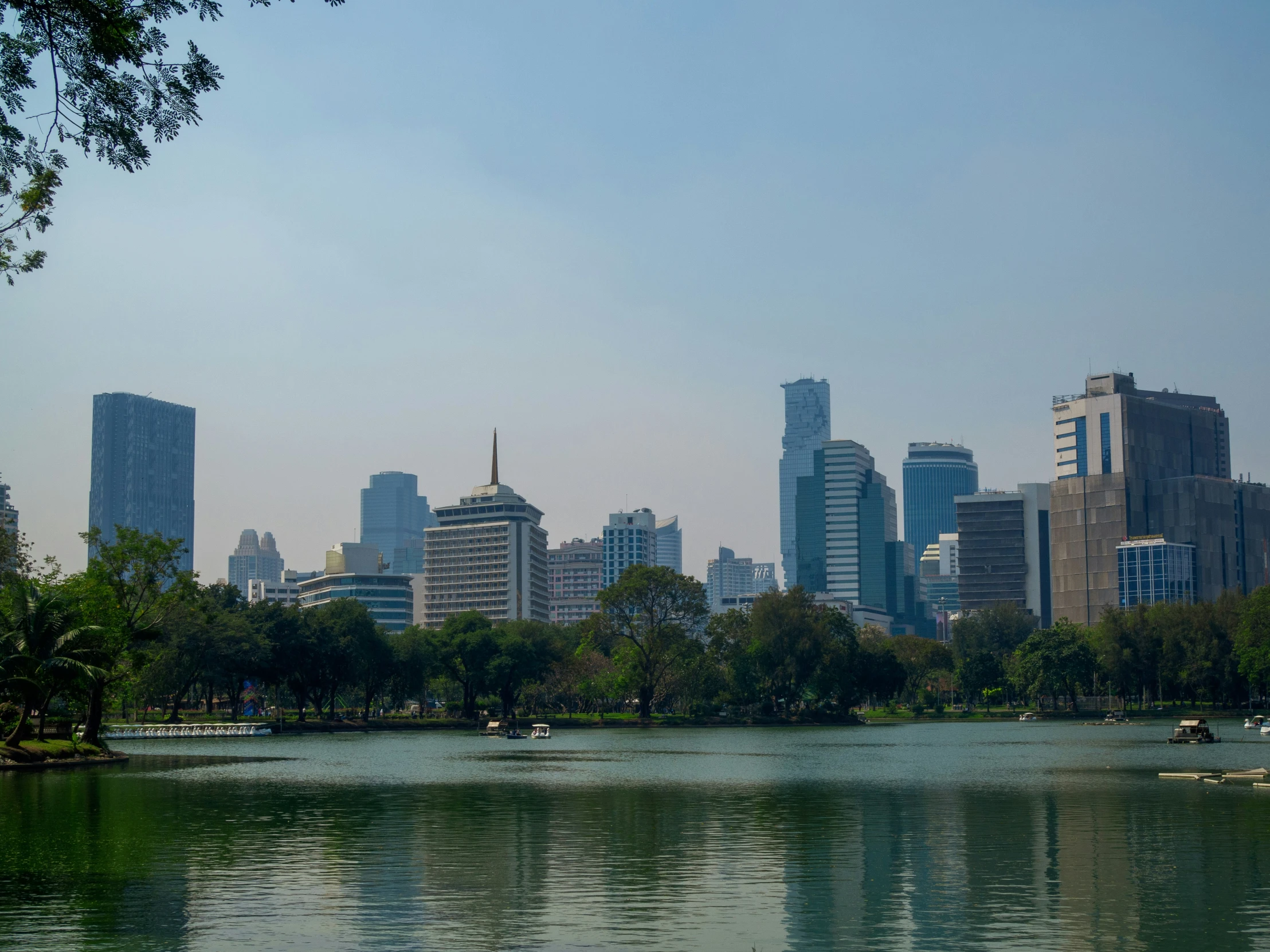 view of a city skyline with skyscrs and boats