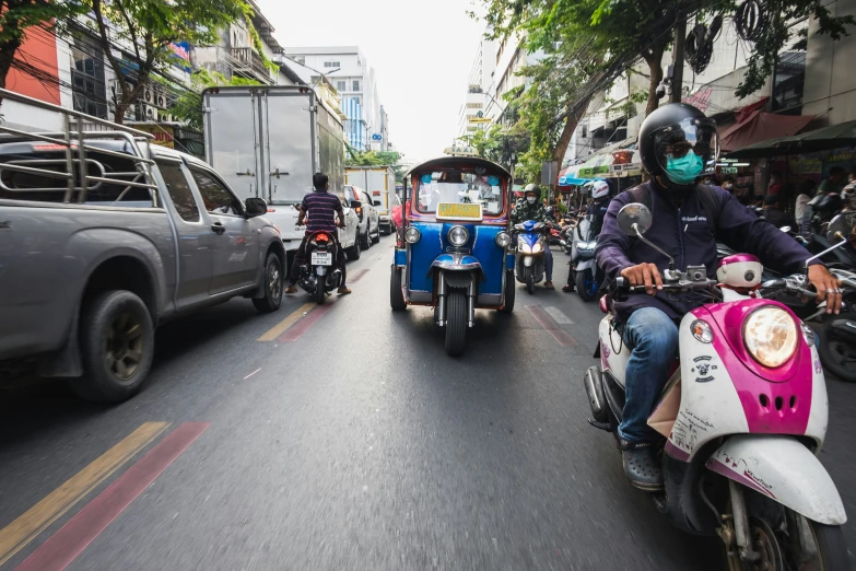 motorcycles with passengers going down the road during the day