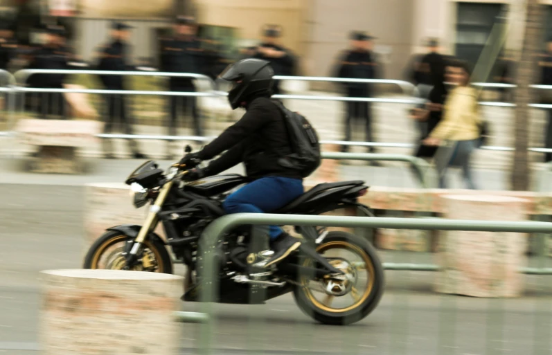 a person wearing a helmet rides a motorcycle through an outdoor area