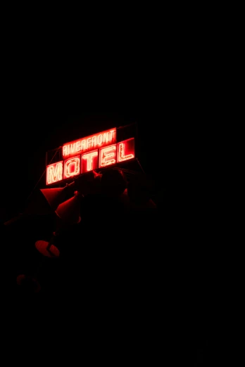 a neon sign on top of the building