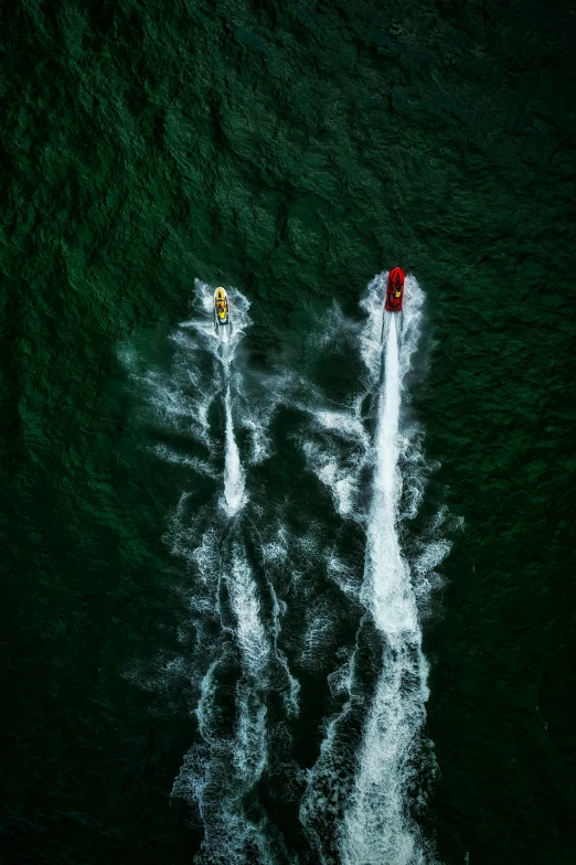 a boat glides through the water near two boats