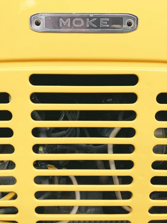 the front grill of a yellow truck that reads e