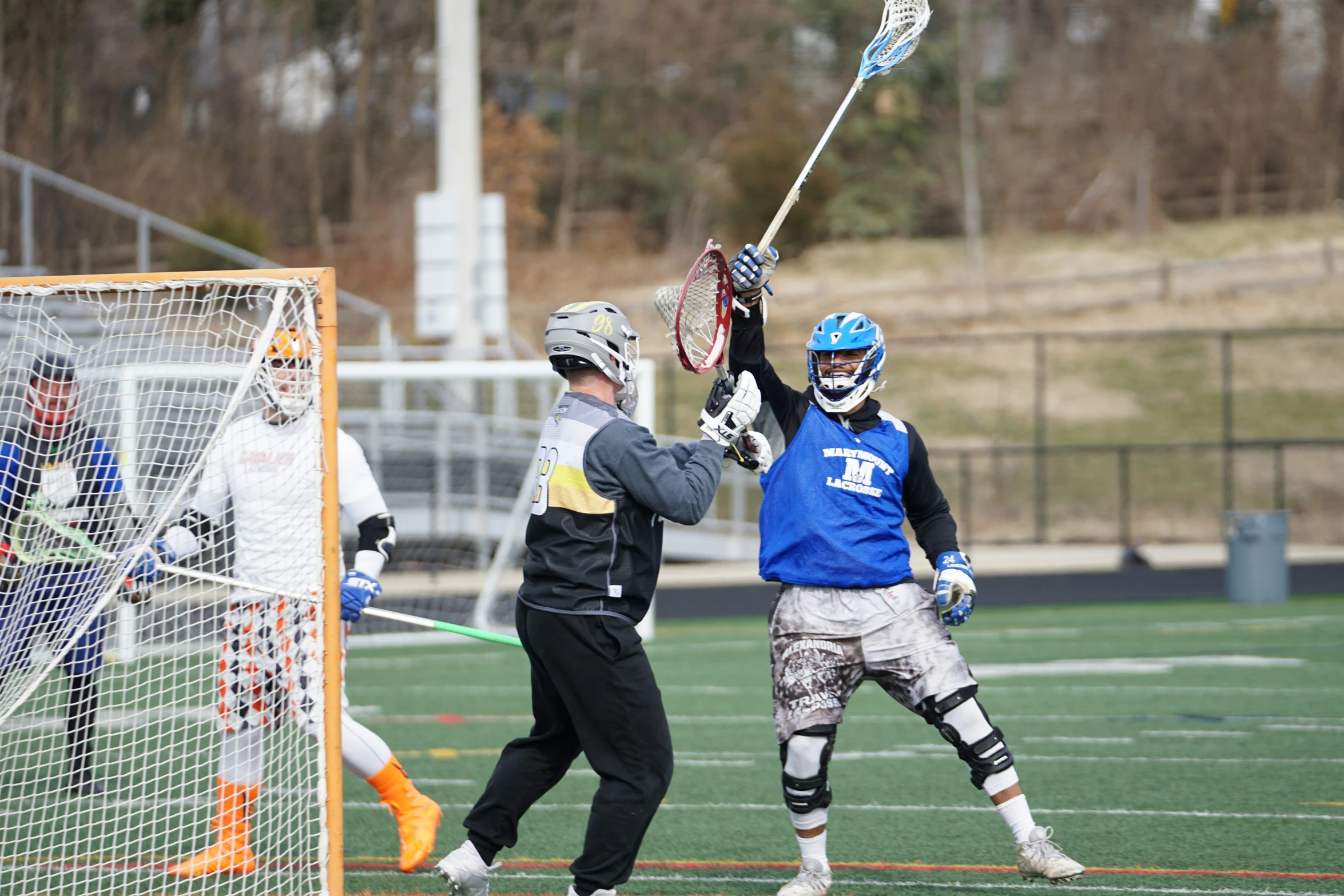 a man holding onto a lacrosse ball during a game