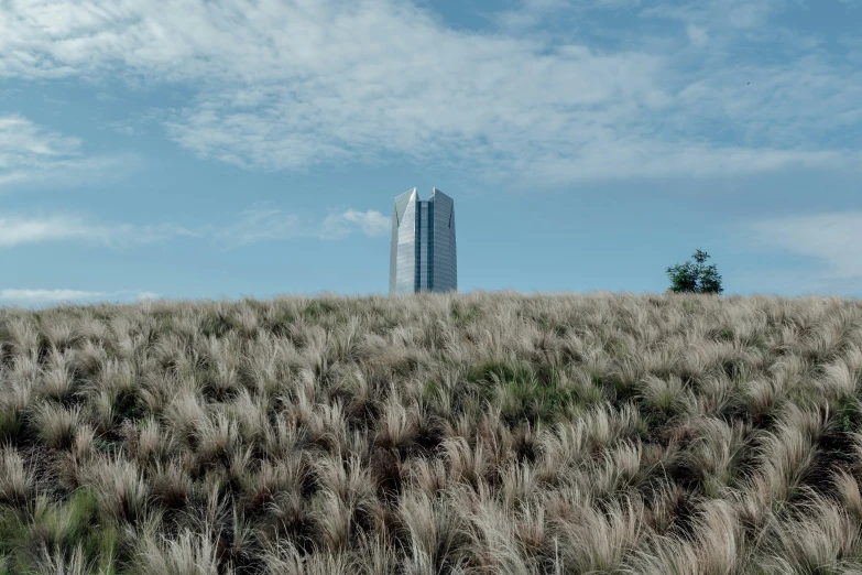 a view of a tall building on a hill