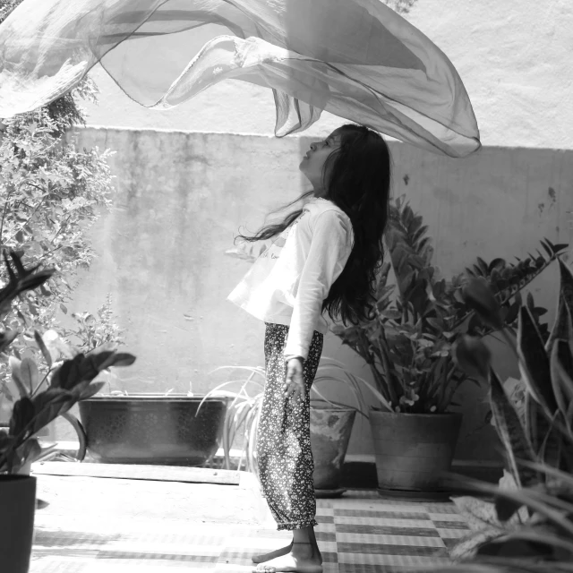 black and white po of a woman holding an umbrella