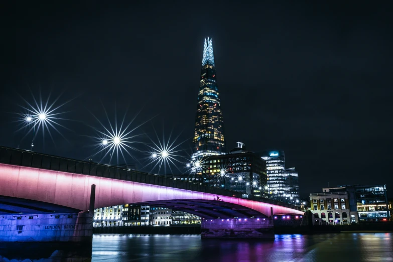 a view of a cityscape from across the river at night