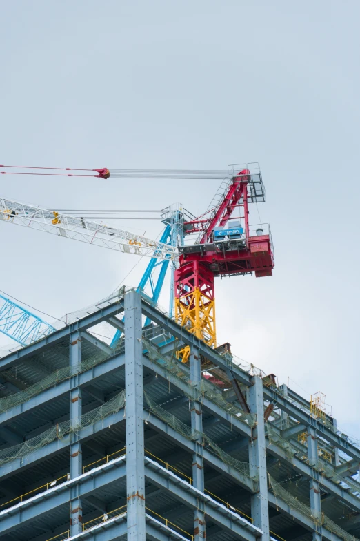 there is a crane on top of a tall building