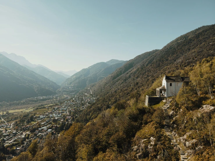 a very steep looking building in the middle of a mountainside