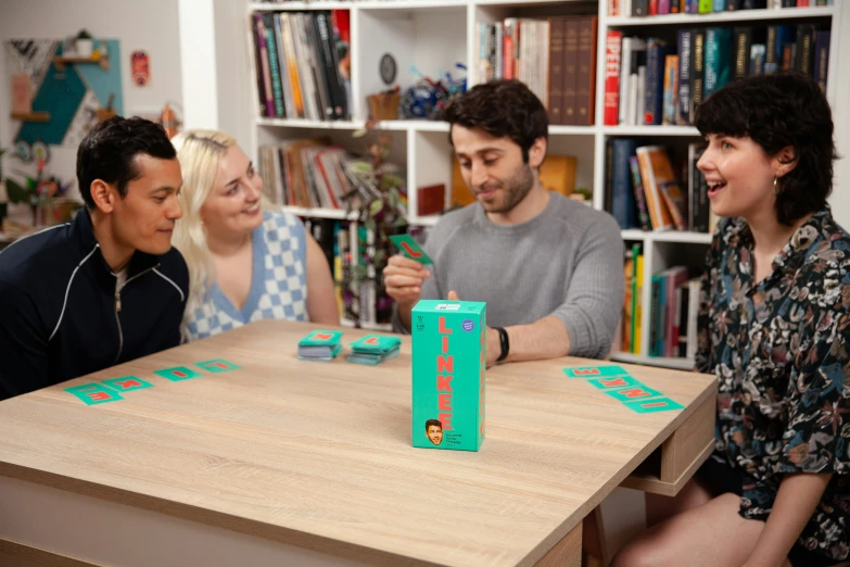 a group of people sitting around a table playing board games