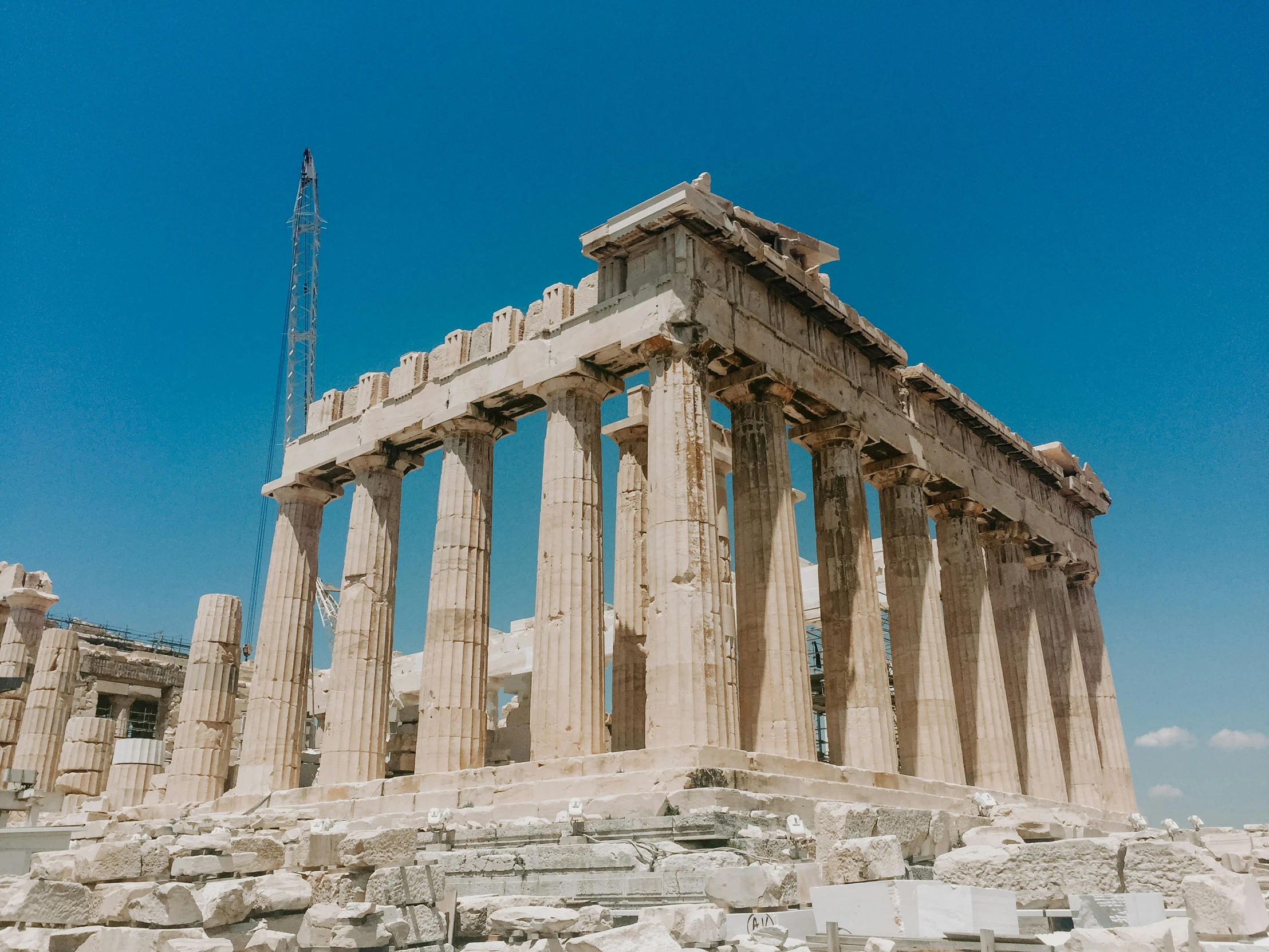 some tall columns that are on the side of a hill