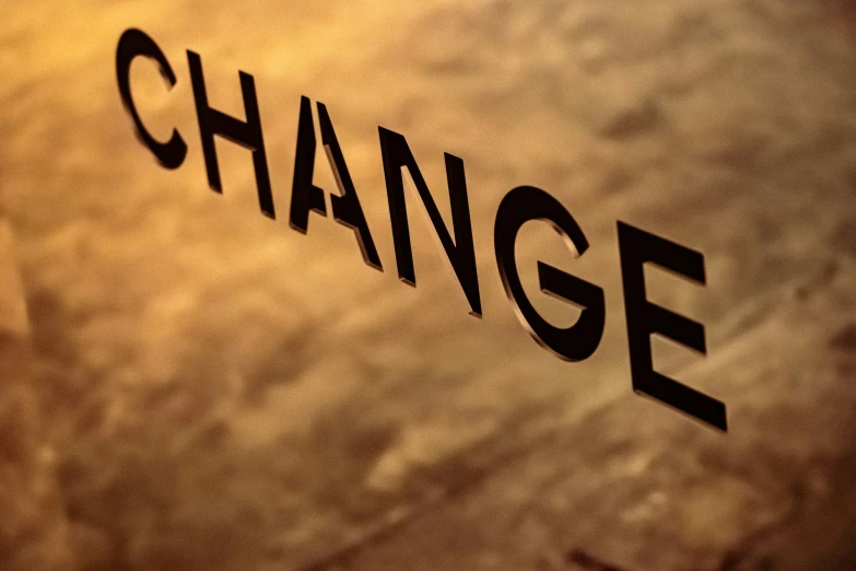 the word change projected on a glass window