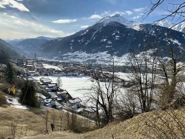 snow covered mountains and a small town on a hill