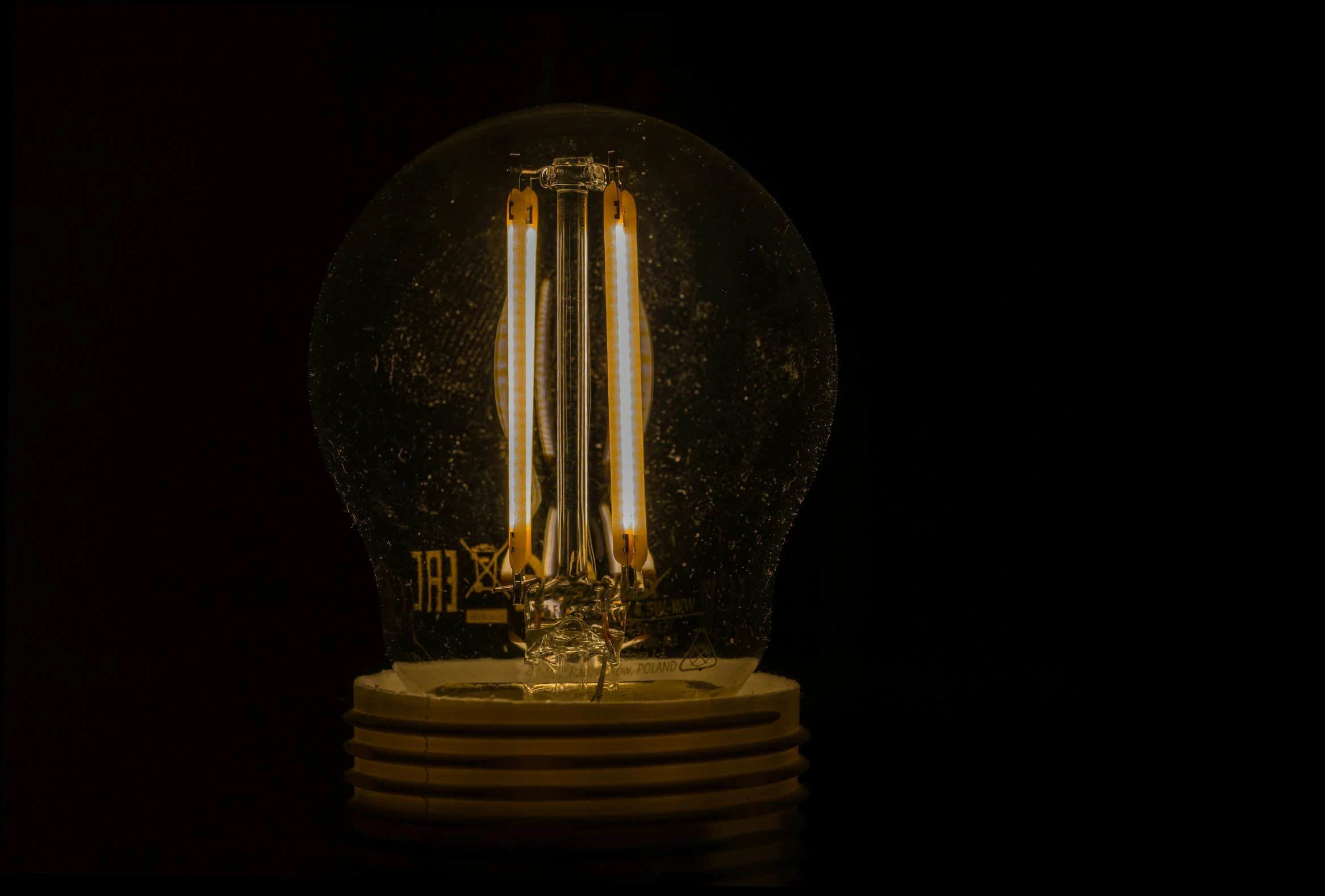 an antique clock in a glass globe with golden lights