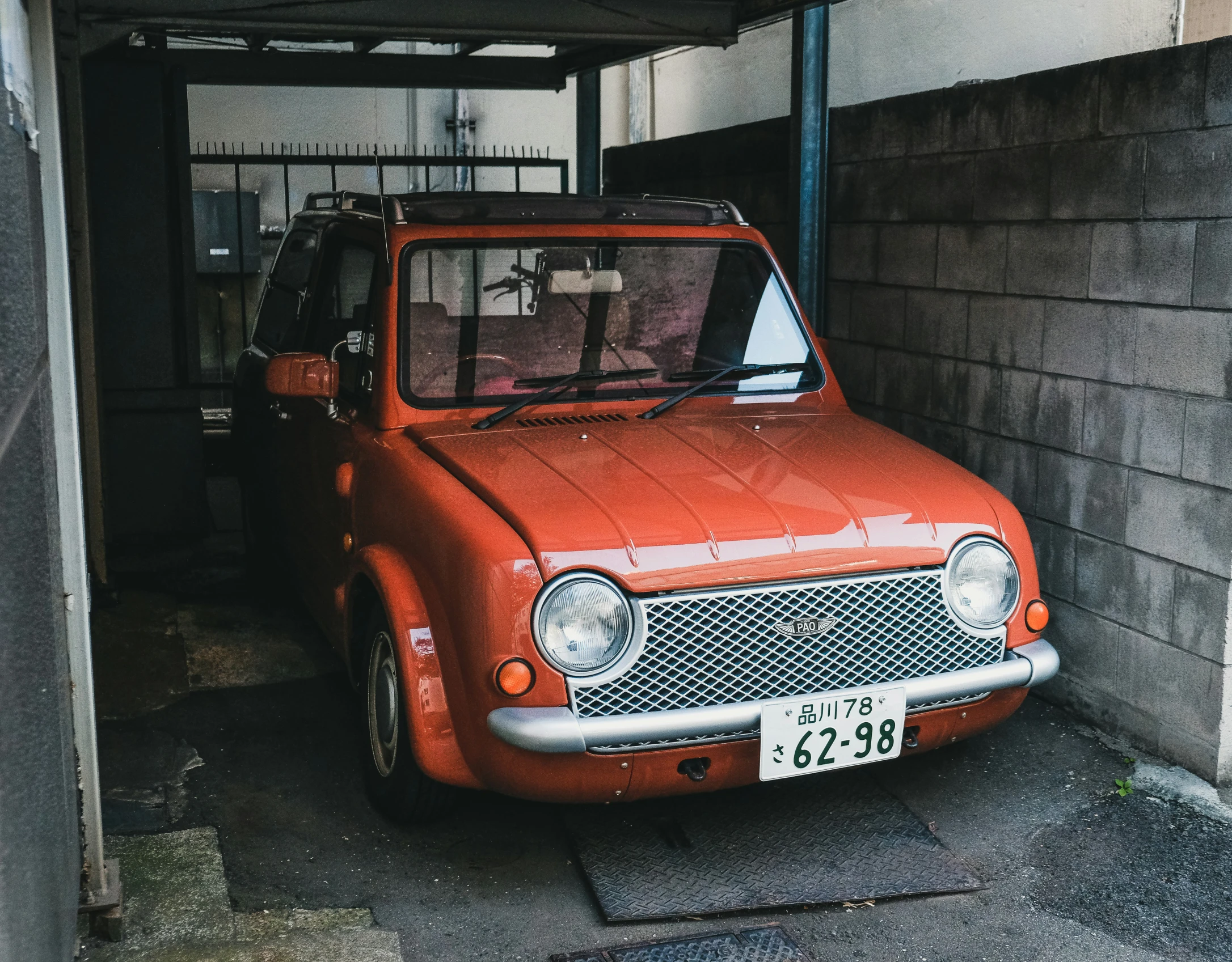 an old red truck sitting in the back yard