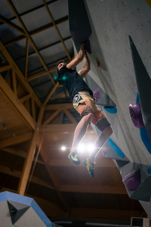 a person is standing on the top of a rock wall