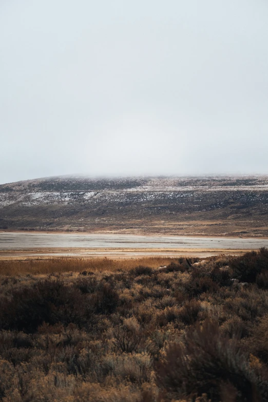 a single snow covered mountain in the distance