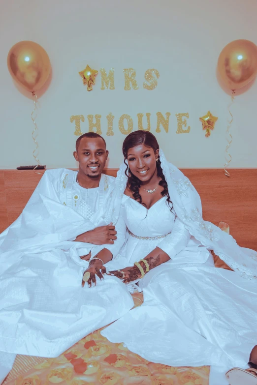 a couple in wedding dresses posing for a picture