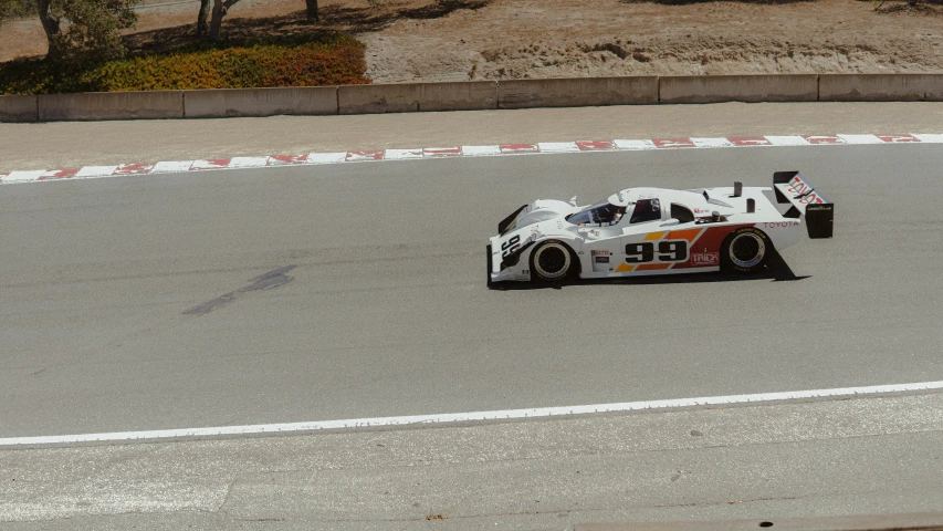 a man driving a racing car down a track