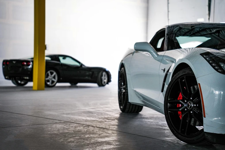 two luxury sports cars parked in a garage