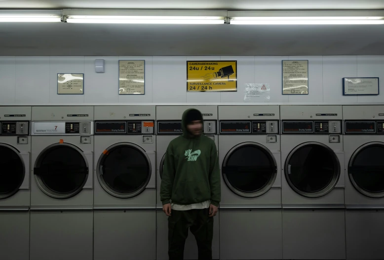 a guy standing in front of a large row of machines