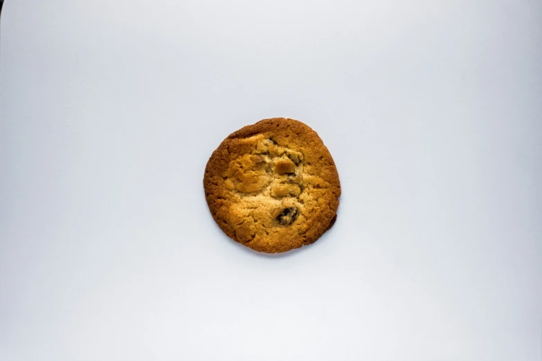 a cookie sitting on top of a white surface