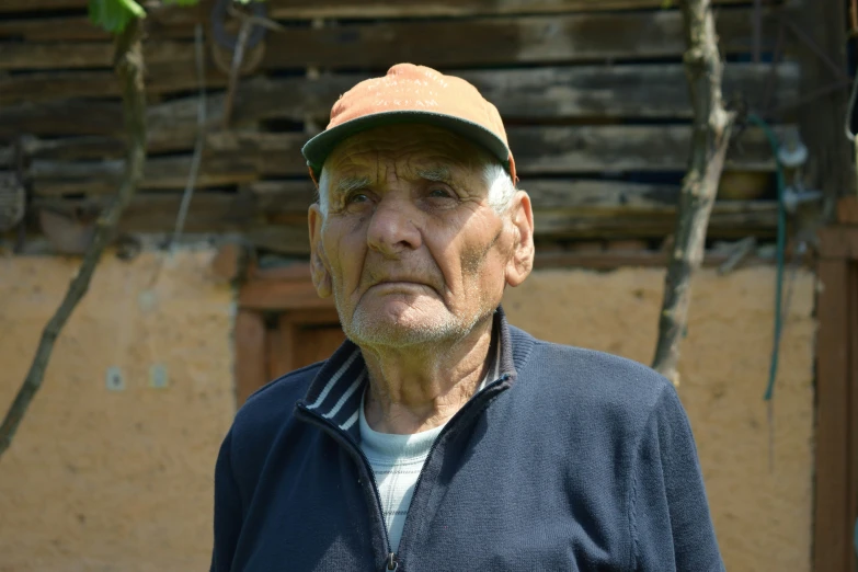 a man is wearing a baseball hat looking away from the camera