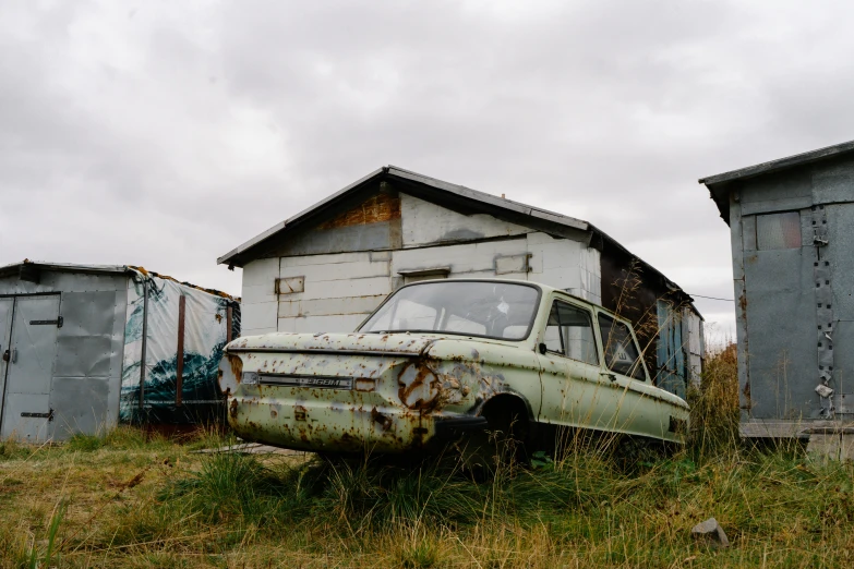 an old run down truck is sitting in a field