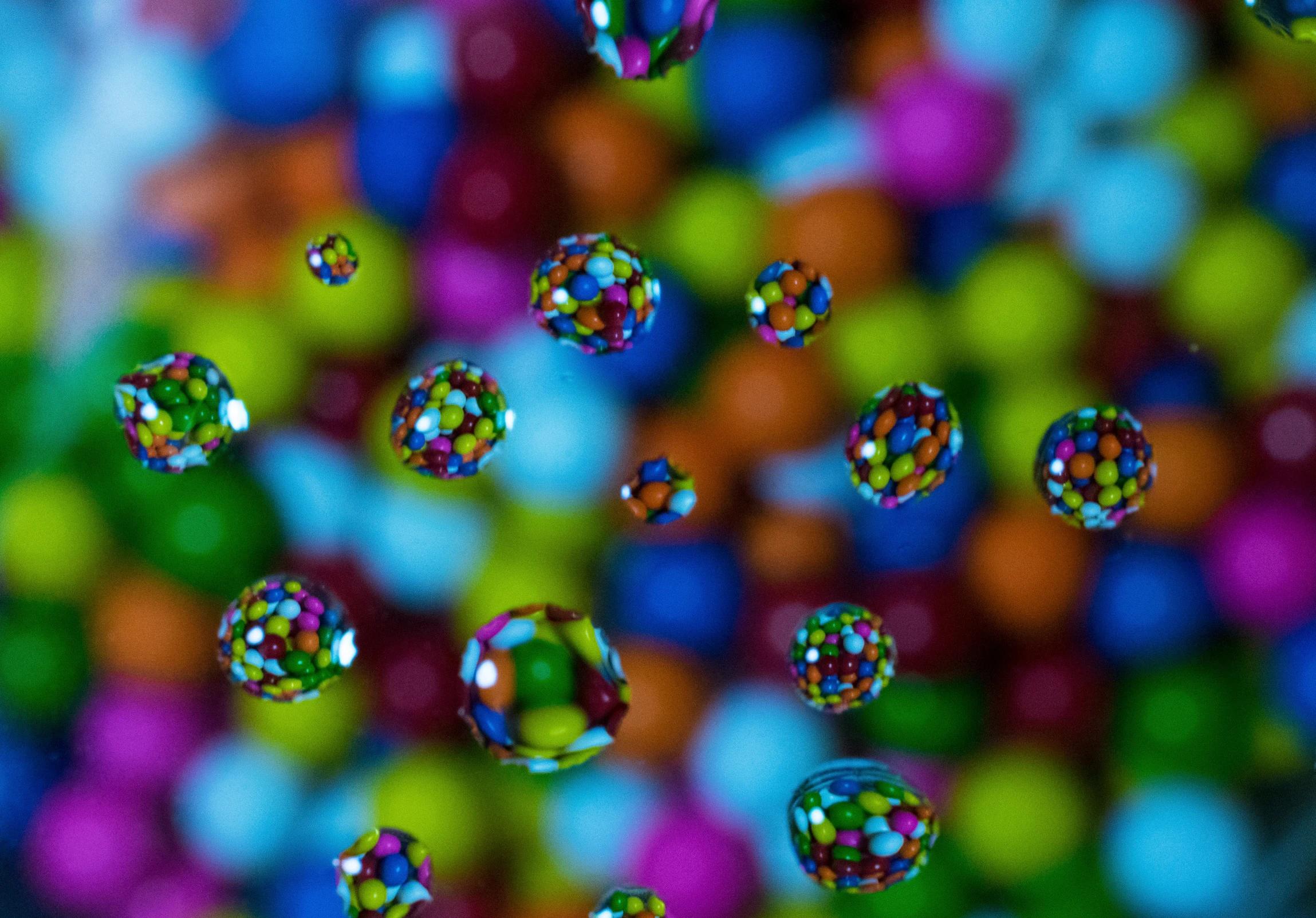 an assortment of colorful bubbles floating over the surface