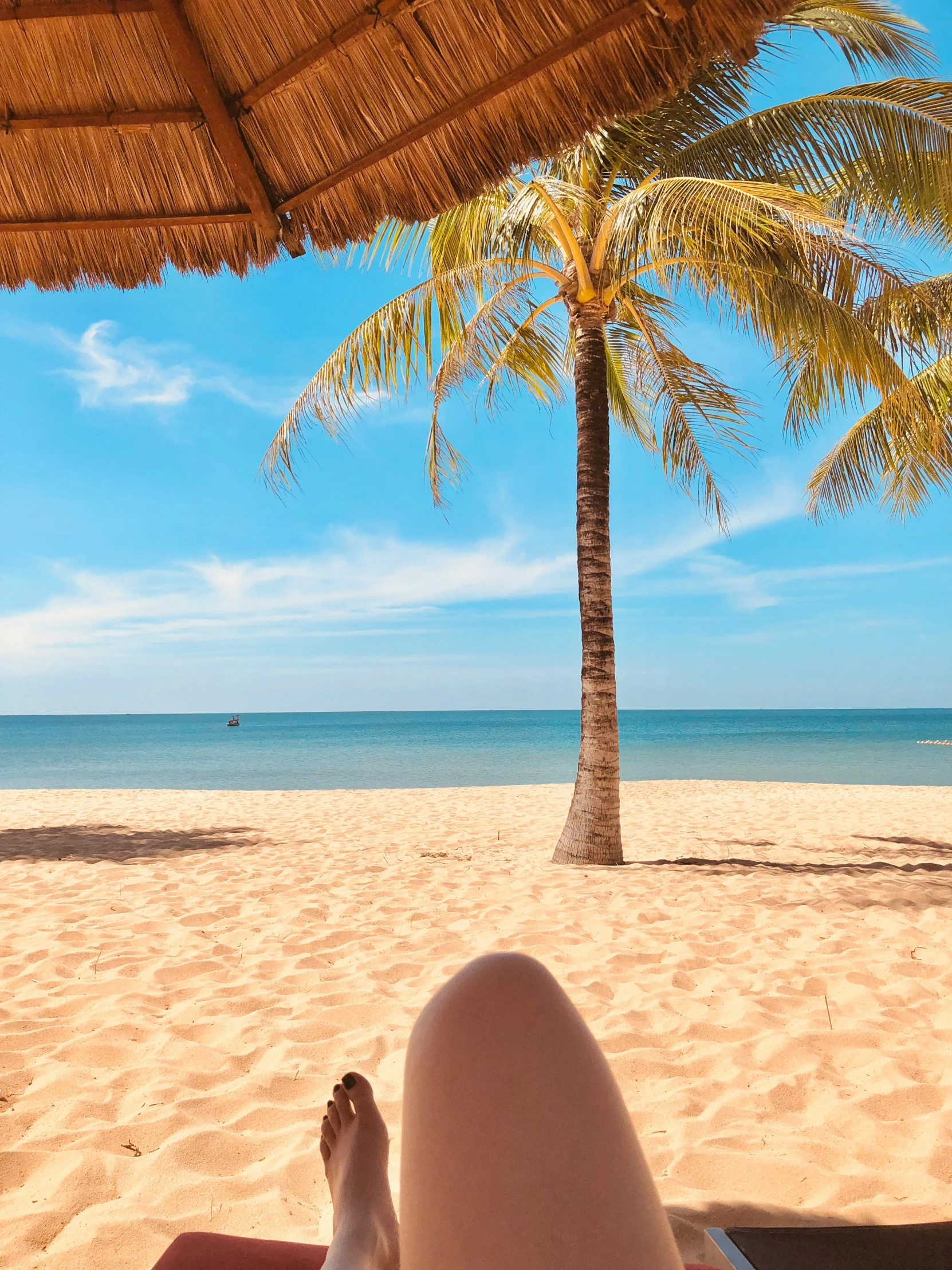 there are people on a beach under an umbrella