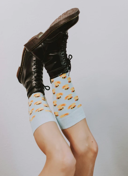 the woman's socks have different types of hamburgers on them