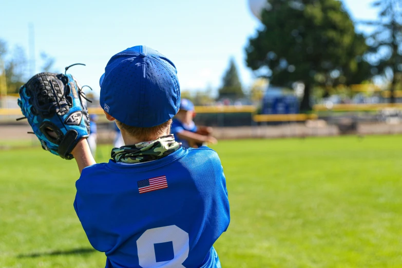 a little league player about to throw the ball