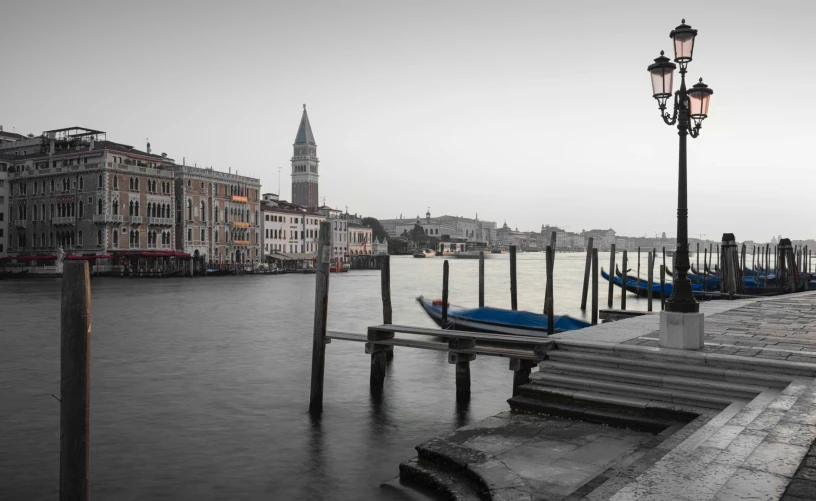 a boat docked next to a light pole