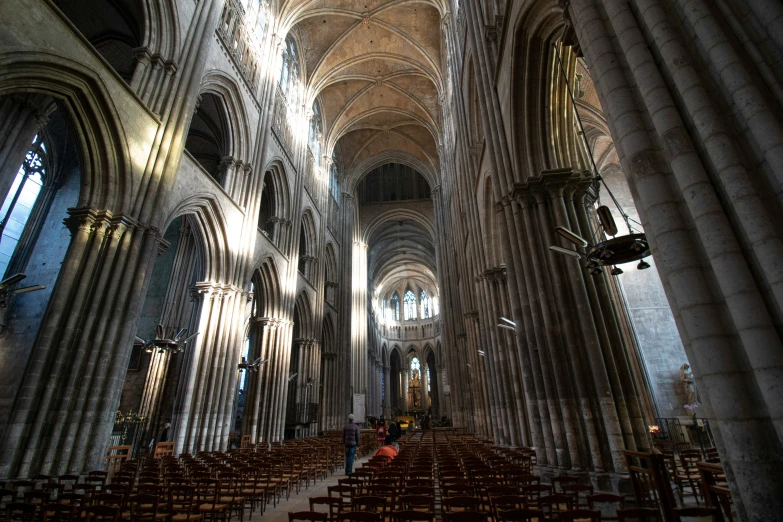 the interior of an empty cathedral filled with chairs