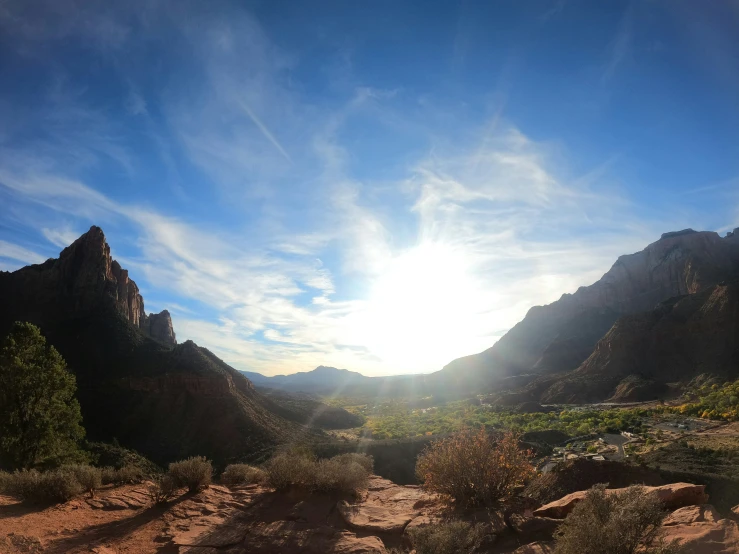 a landscape view of a mountainous mountain range and a sky with some clouds