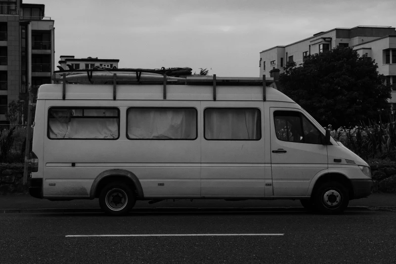 black and white po of a bus parked in the middle of the road