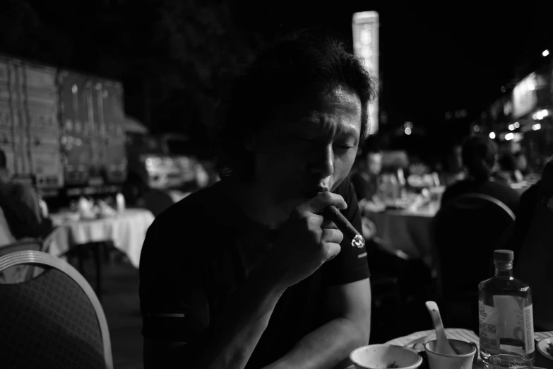 man sitting at a table eating food on top of a plate