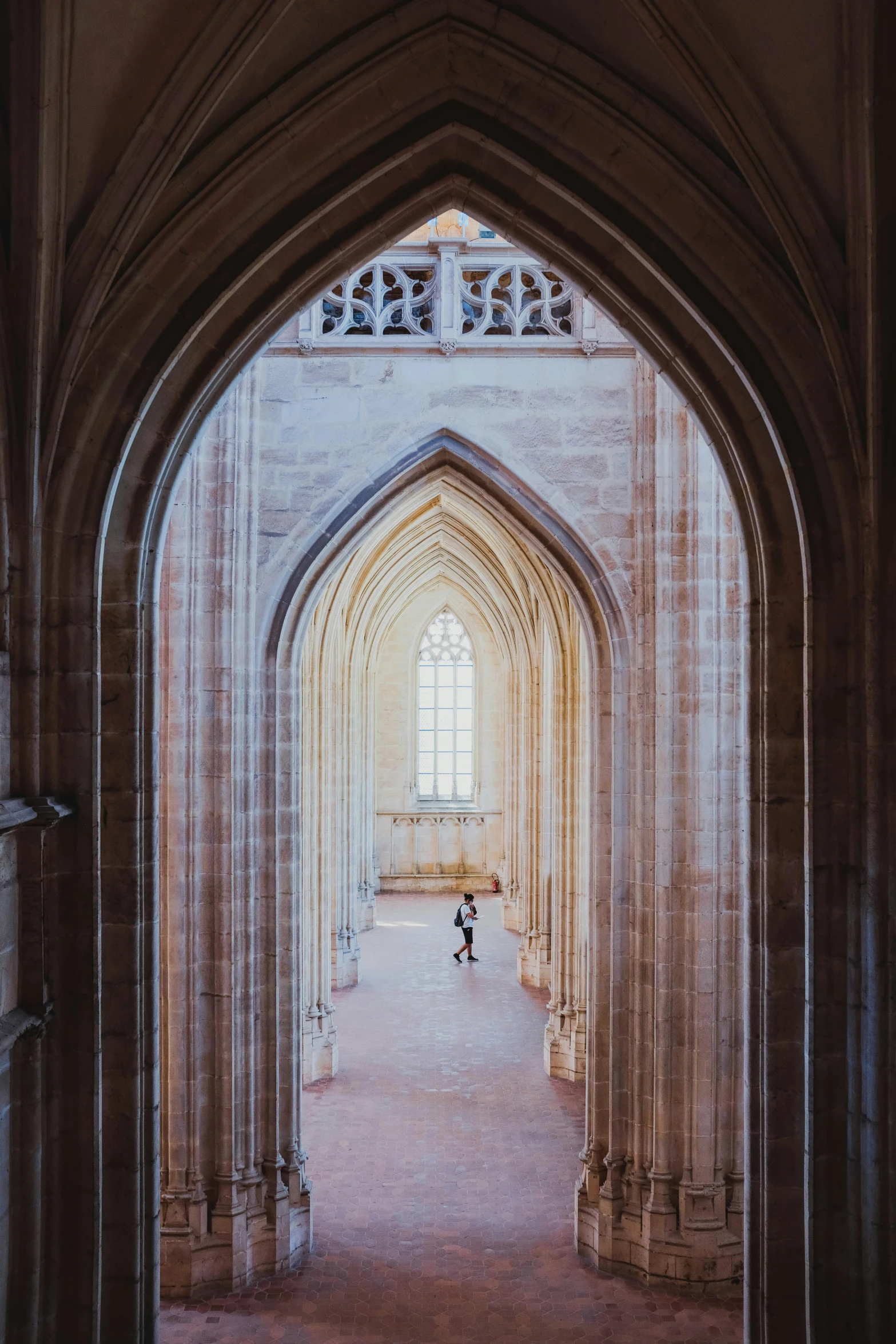 a person is walking through an arched tunnel