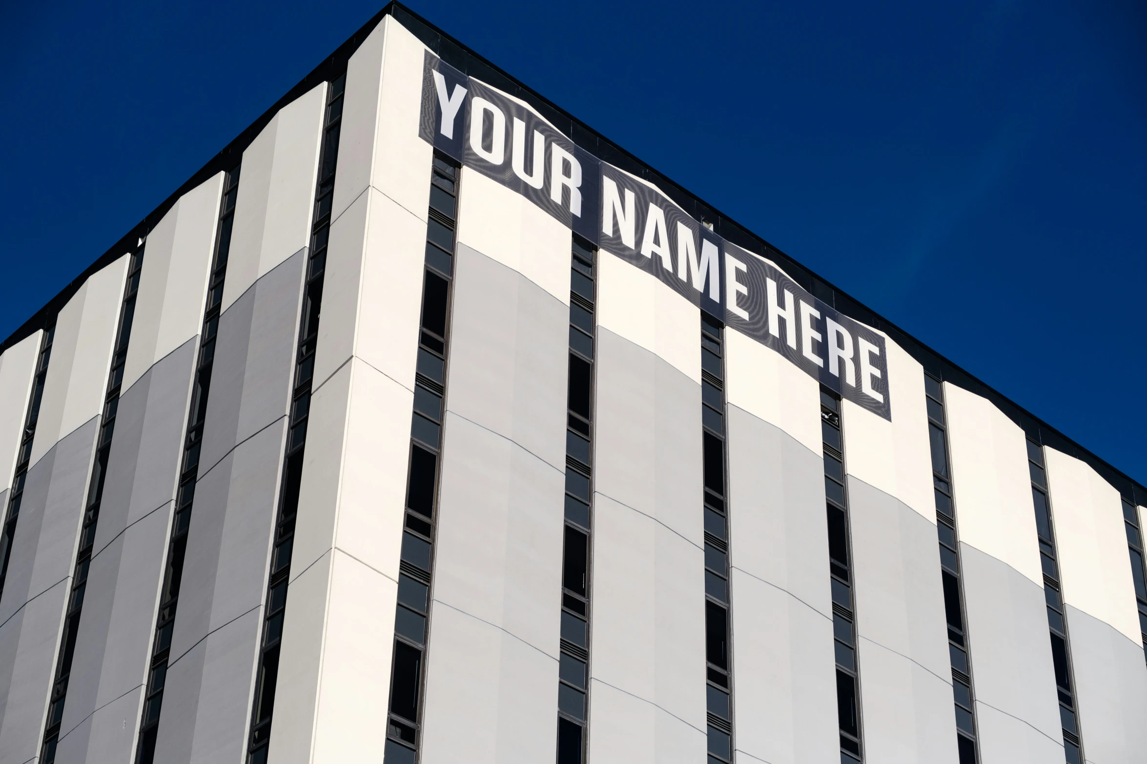 an empty white building with a sign on the corner