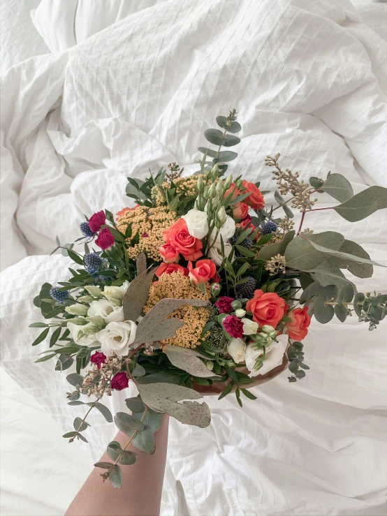 the bridal bouquet is placed on the bed