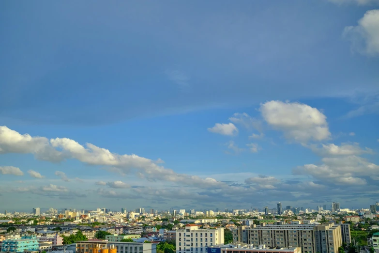 the sky is blue and gray and cloudy above the city