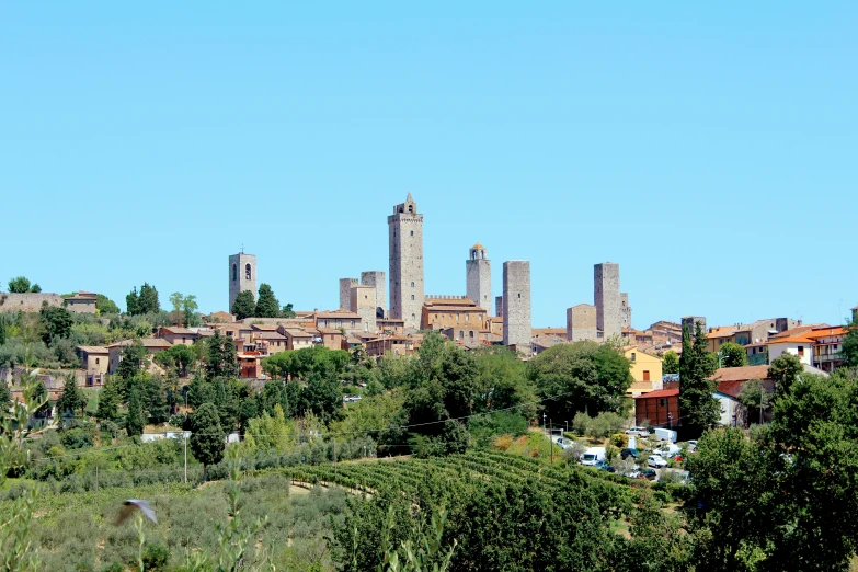 a city surrounded by trees and tall towers