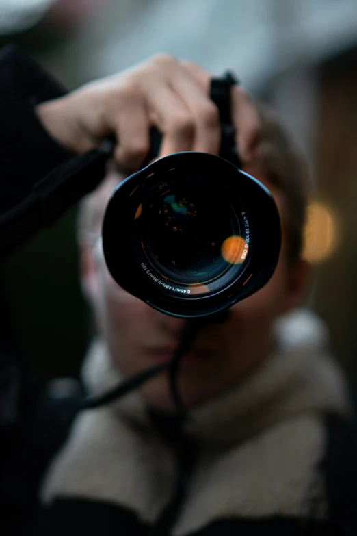 the man is taking a picture through a camera