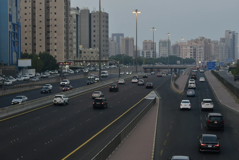 a freeway filled with lots of traffic and surrounded by tall buildings