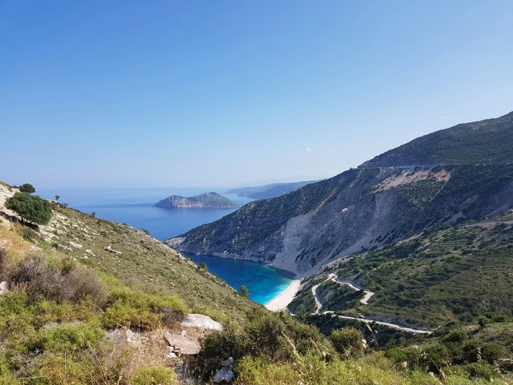 a road on the side of a mountain overlooking the sea