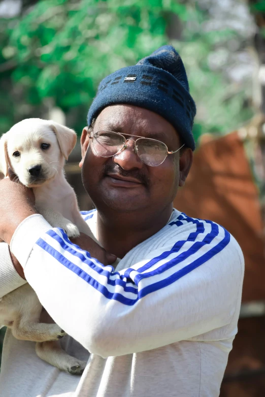 a man holds a puppy in his hands