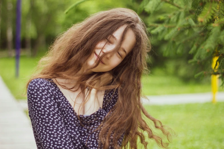 the young woman is smiling and looking sad