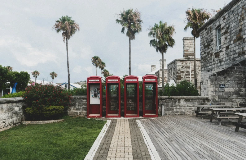 a row of red cell phones on a park path