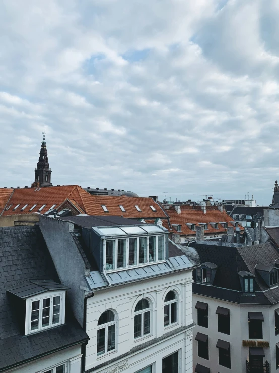 buildings are in the foreground of a view of a cloudy sky