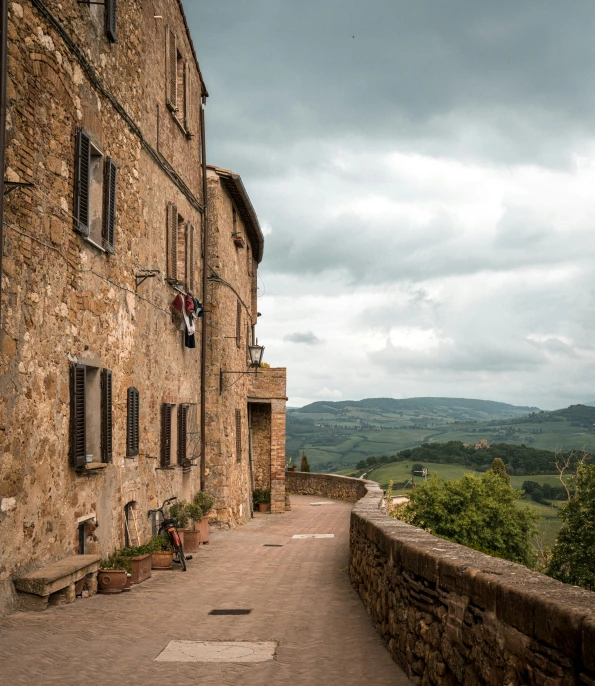 a stone building with open windows and a balcony