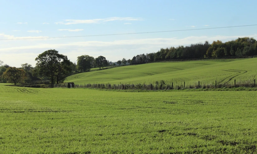 the countryside with grass is covered with green hills